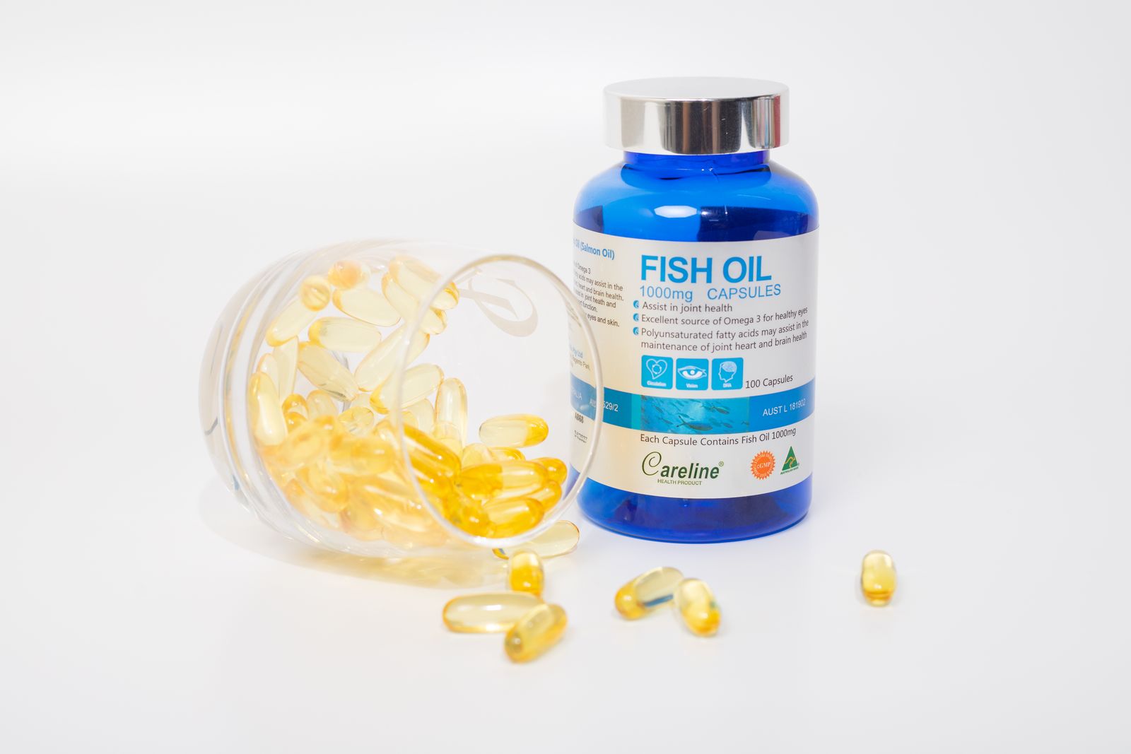 Fish oil capsules spilling from a bottle
