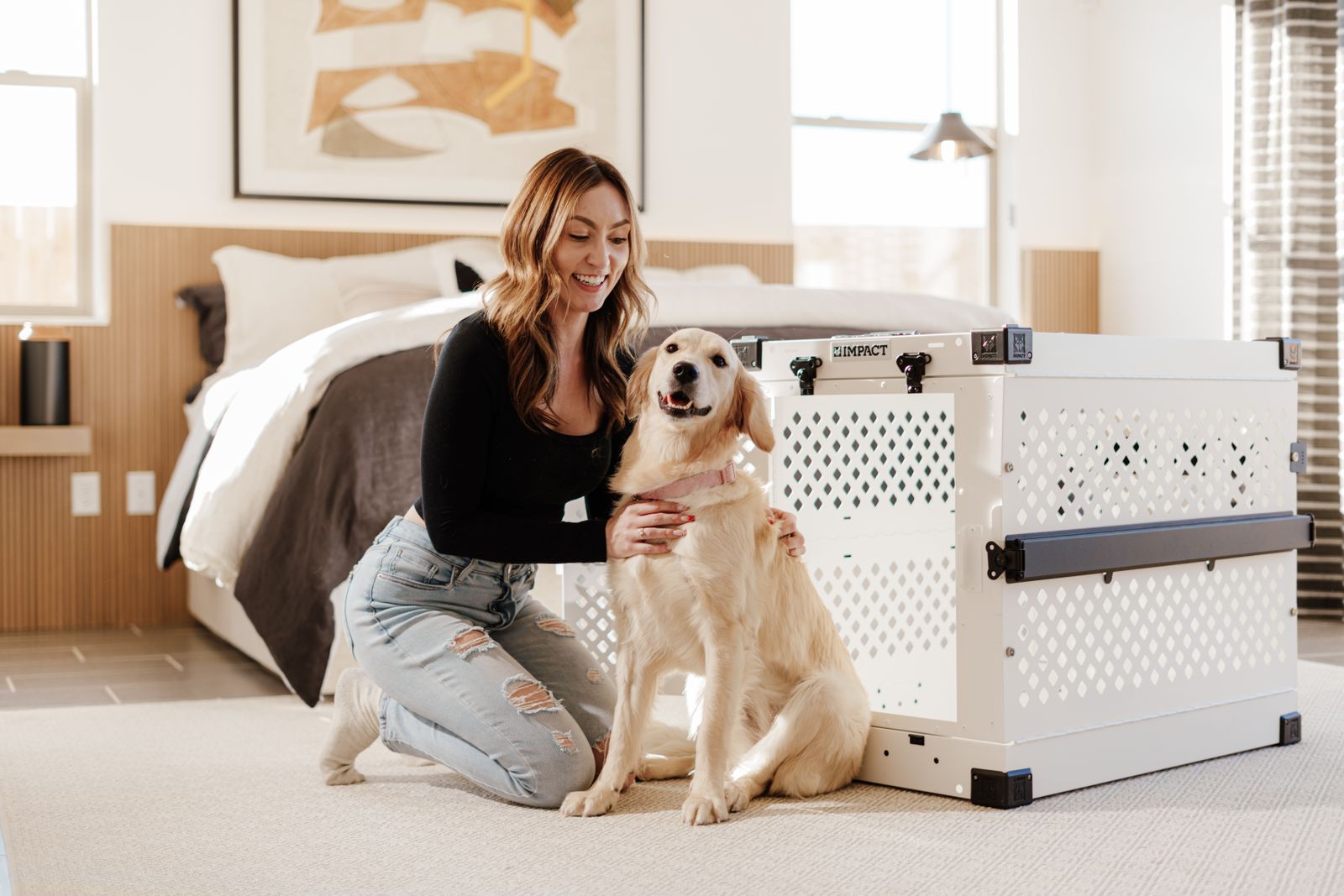 A golden retriever beside a dog crate in a bright bedroom